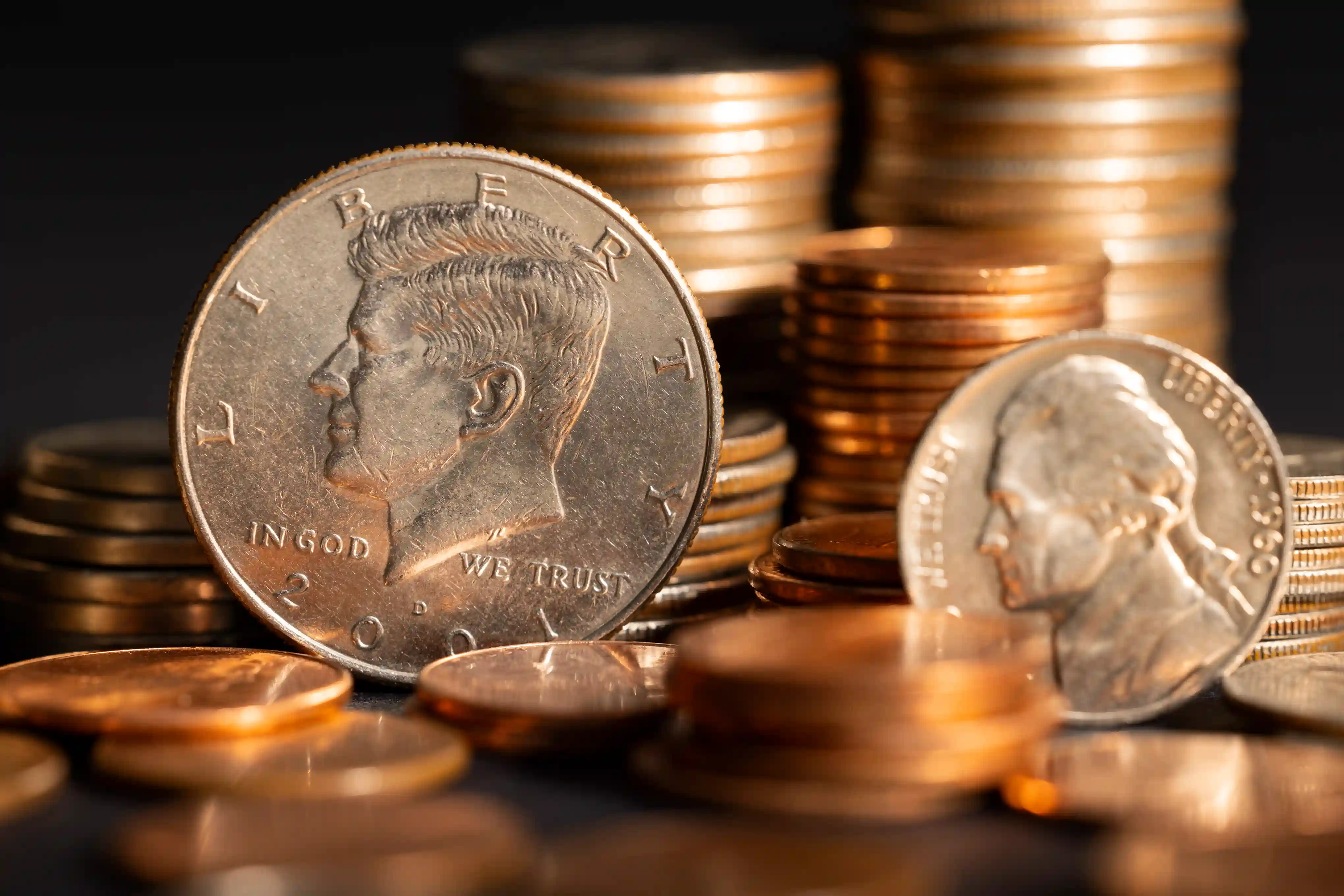 a lot of different coins with an Eisenhower dollar in a foreground